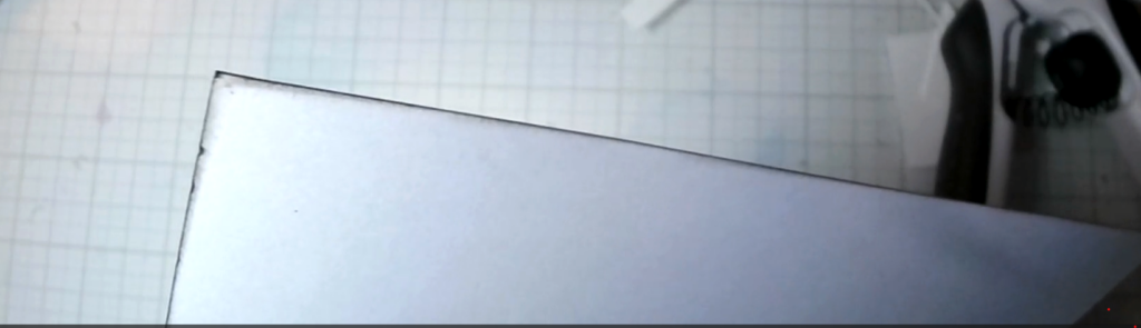 The edges of the musical-note card front being darkened with brown Distress Ink.