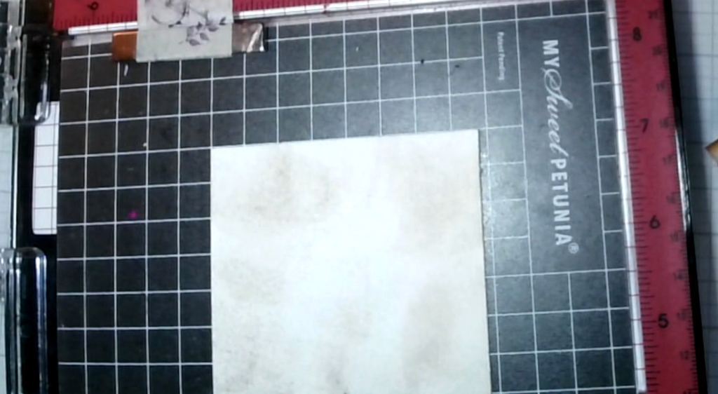 Neutral paper being inked in brown to coordinate with the musical card layers.