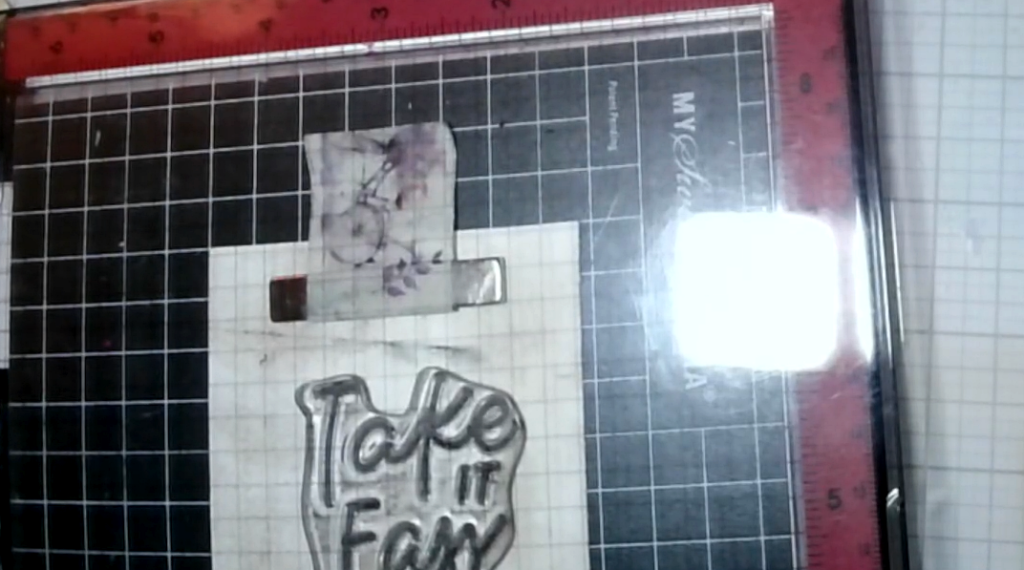 The “Take It Easy” sentiment being stamped in dark-brown ink